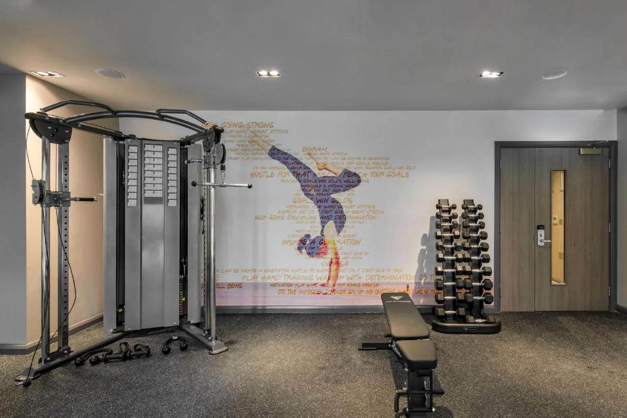 a room with a gym with a wall with a painting at Maldron Hotel Manchester City Centre in Manchester